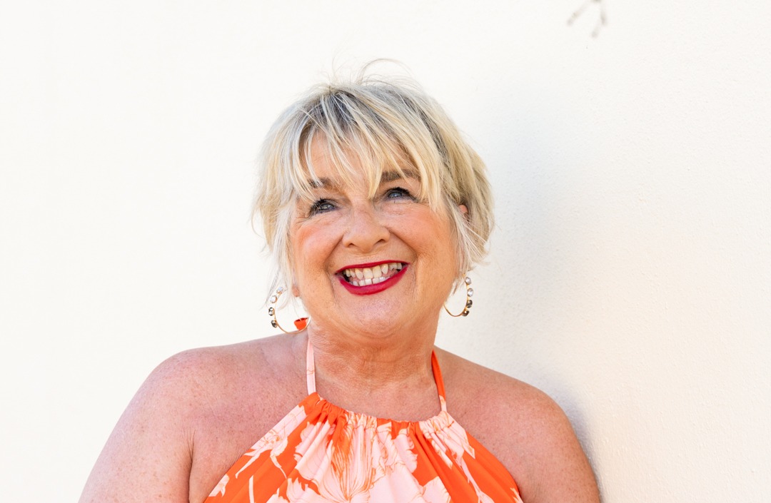 Jackie standing in front of a white wall